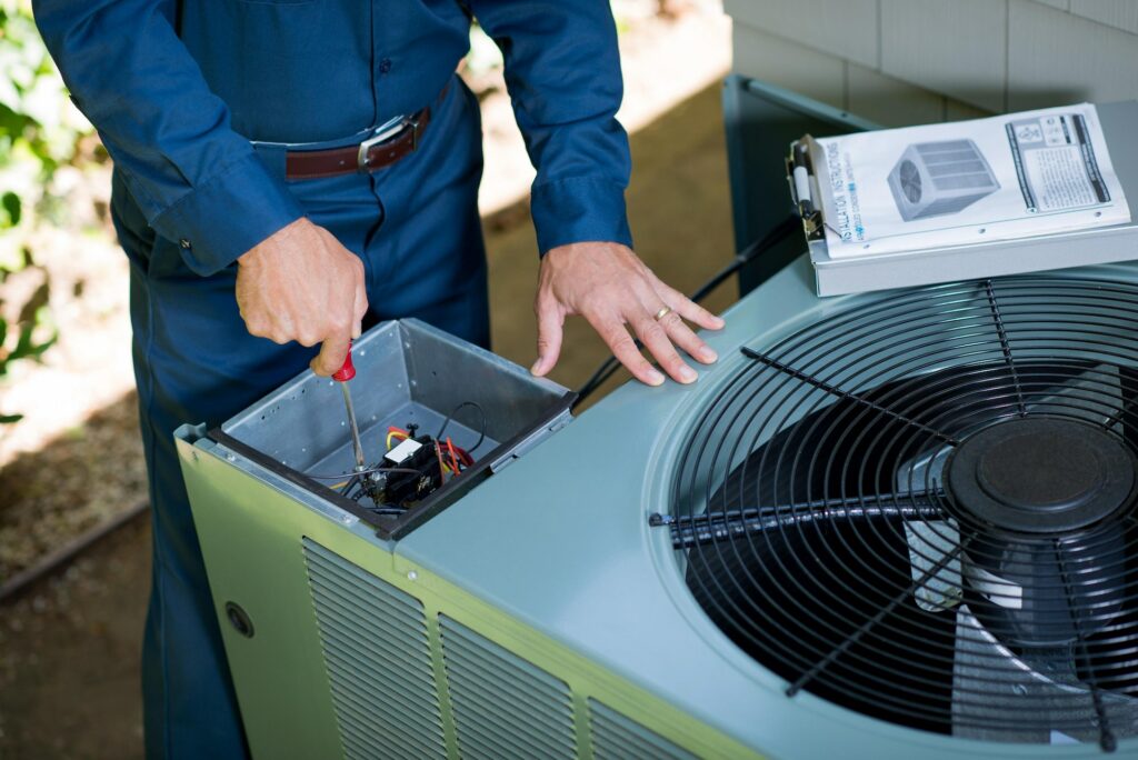 Technician repairing a commercial HVAC system